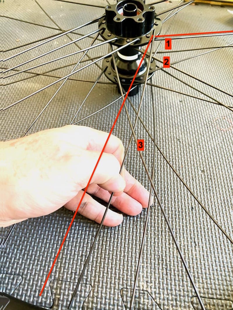 wheel lacing - first cross spoke